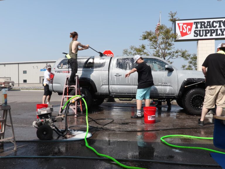 Members participating in a community car wash